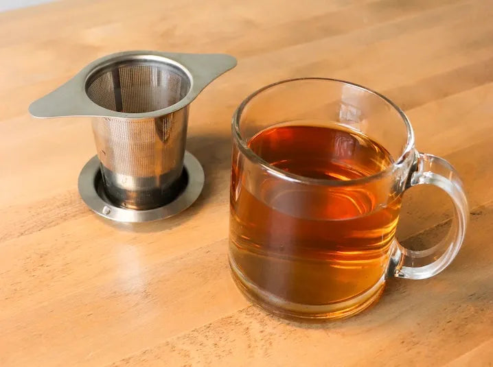 Tea infuser brewing loose leaf Japanese green tea in a cozy setting