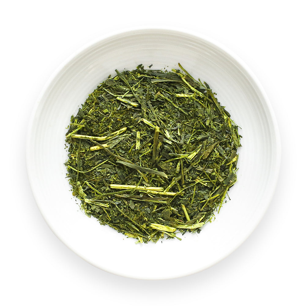 Japanese Fukamushi Sencha Deep Steamed Green tea loose leaves in a white bowl on a white background