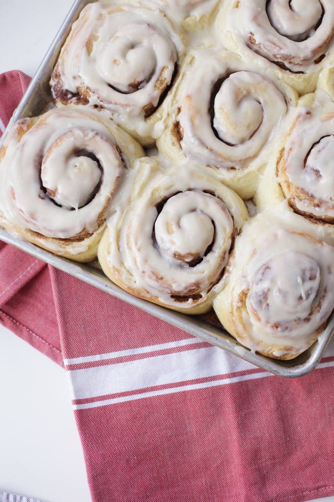 Giant cinnamon rolls baked in pan and drizzle with glaze.