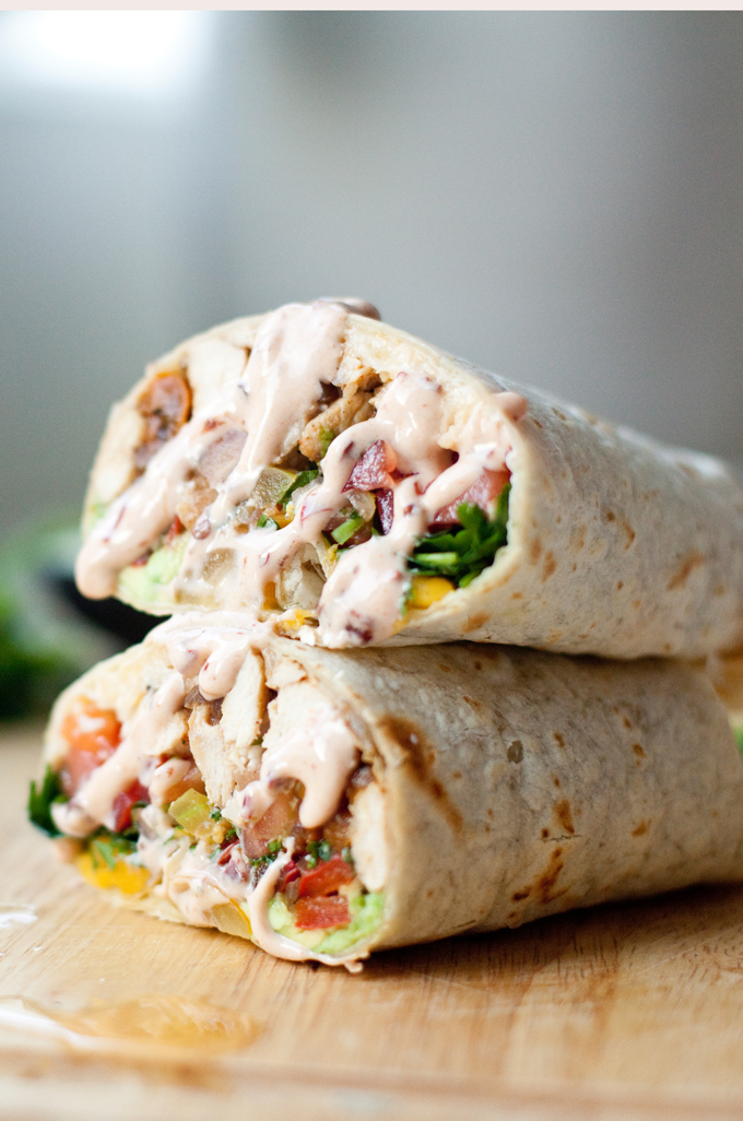 Chipotle sour cream drizzled on top of chicken wraps.
