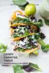 Three crispy carnitas tacos filled with greens, radishes, and cheese are displayed on a white surface with scattered salad leaves. A lime and a jar of dressing are nearby, perfectly complementing the fresh flavors of the carnitas tacos. Text on the image reads: Crispy Carnitas Tacos Macro-Friendly & Delicious.