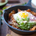 5 Minute Skinny Chilaquiles with toppings in a small cast iron skillet.