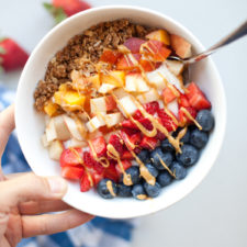 Picture of yogurt and cottage cheese breakfast bowl topped with colorful fruit.