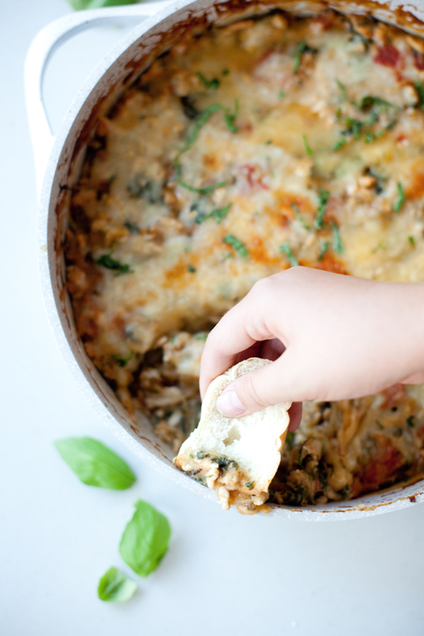Dipping bread into cheesy spaghetti squash bake.