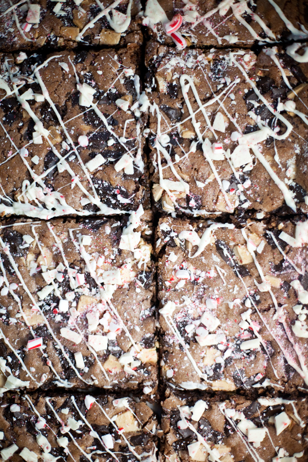 The best brownies ever, cut into squares, topped with crushed peppermint pieces and drizzled with white chocolate.