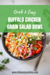 A black bowl filled with shredded buffalo chicken, cherry tomatoes, pickled onions, greens, and grains sits on a marble surface. Text reads: Easy Buffalo Chicken Grain Salad—quick to prepare and perfect for a wholesome meal. www.lillieeatsandtells.com.