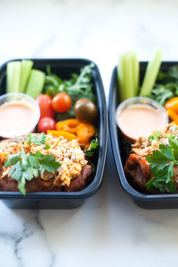 Lunch with baked sweet potato stuffed with creamy buffalo chicken and veggies on the side. www.lillieeatsandtells.com