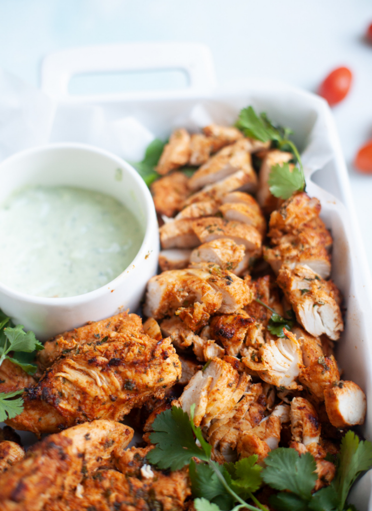 Sliced air fryer chicken tenderloins in a large serving dish.