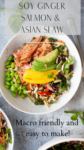A bowl of soy ginger salmon and Asian slaw is served with sliced avocado, mango, edamame, herbs, and seeds. Text reads: Soy Ginger Salmon & Asian Slaw. Macro friendly and easy to make!.