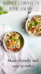 Two bowls of vibrant corn feta and basil salad with cherry tomatoes, onions, and fresh basil sit on a white table with a napkin and spoon. Text overlay reads Summer Corn Feta Basil Salad. Macro friendly and easy to make!.