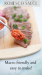 Sliced steak on a wooden board topped with parsley, with a spoonful of flavorful romesco sauce in focus and a bowl of romesco sauce nearby. Text reads: ROMESCO SAUCE. Macro friendly and easy to make!.