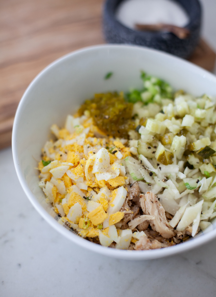 Ingredients for pickle chicken salad in bowl.