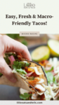 A hand holding an air fryer fish taco with text overlay, "Easy, Fresh & Macro-Friendly Tacos!"
