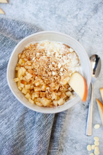 Macro friendly apple crisp yogurt and cottage cheese bowl with toppings.