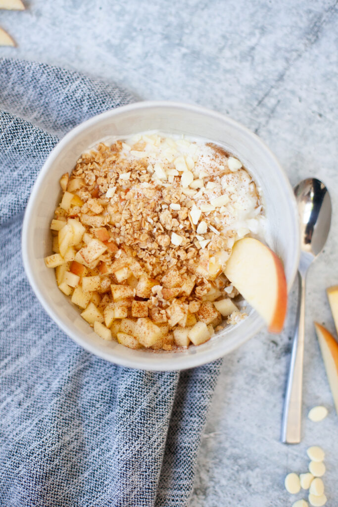 Macro friendly apple crisp yogurt and cottage cheese bowl with toppings.