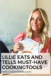 Woman with long blonde hair wearing a pink top smiles while holding cookbooks. Text overlay reads, Lillie Eats and Tells Must-Have Cooking Tools—featuring kitchen favorites every cook will love. Website URL displayed at the bottom.