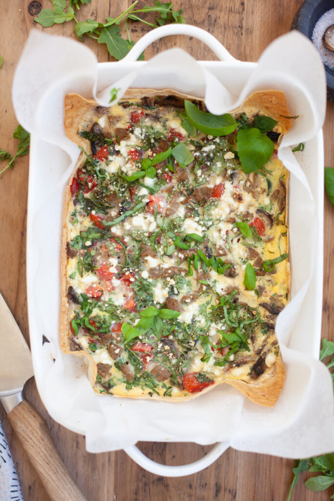 Garden Veggie Quiche baked in a white baking dish.