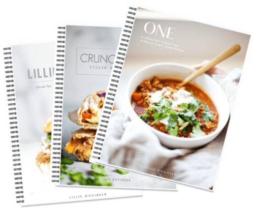 Three spiral-bound cookbooks overlap; the front cover shows a bowl of chili with a wooden spoon, garnished with cilantro, and the titles ONE, CRUNCH, and LILLIE are visible on each book.