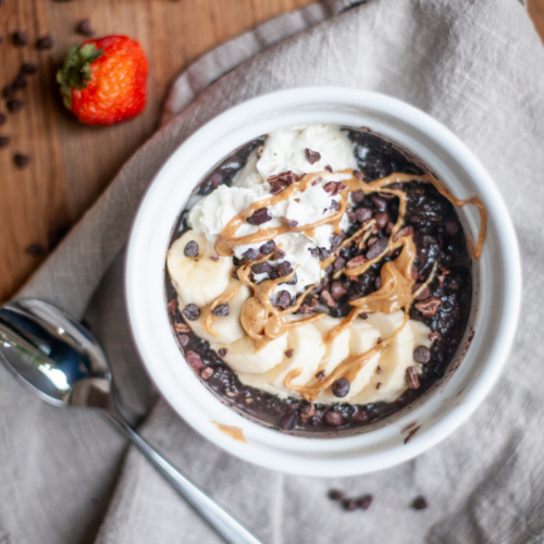 Microwave zucchini brownie oats in ramiken topped with reddi whip and peanut butter.