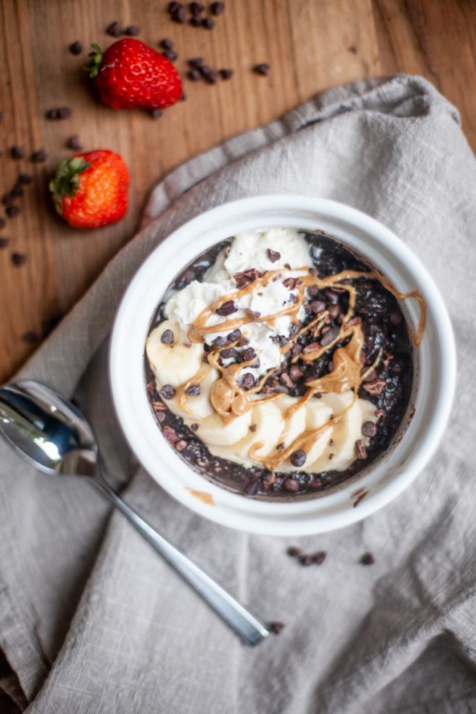 Micorwave zucchini brownie oats in ramikin topped with reddi whip and peanut butter.