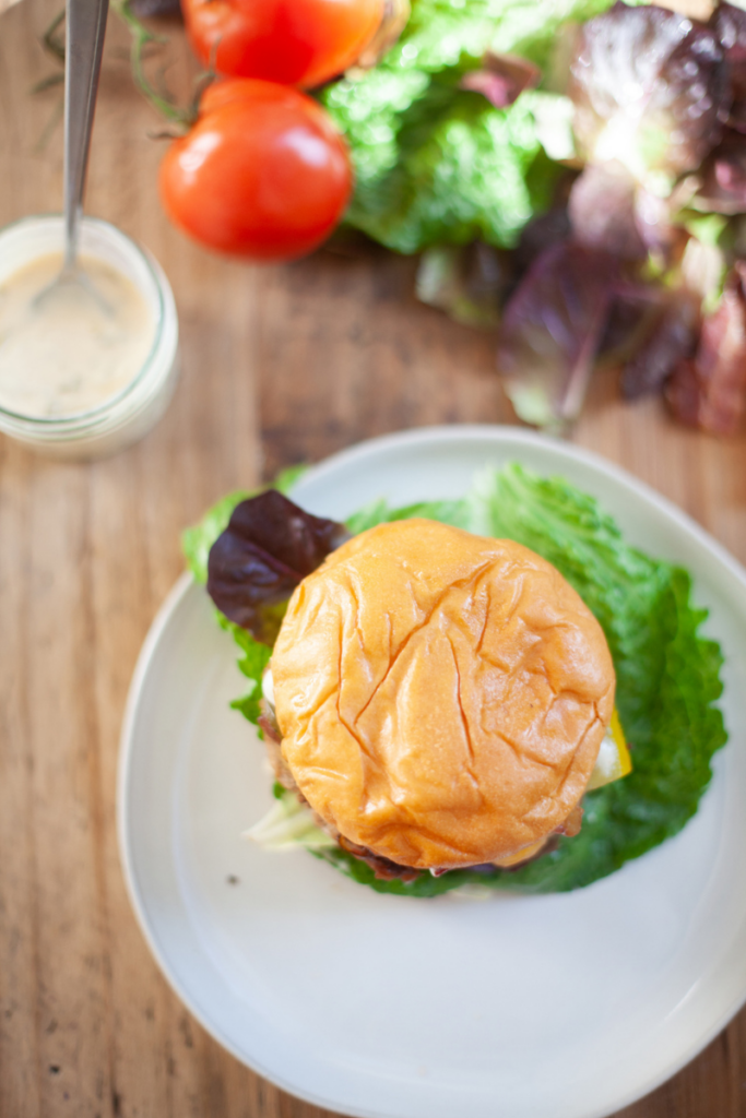 Brioche bun on a white plate.
