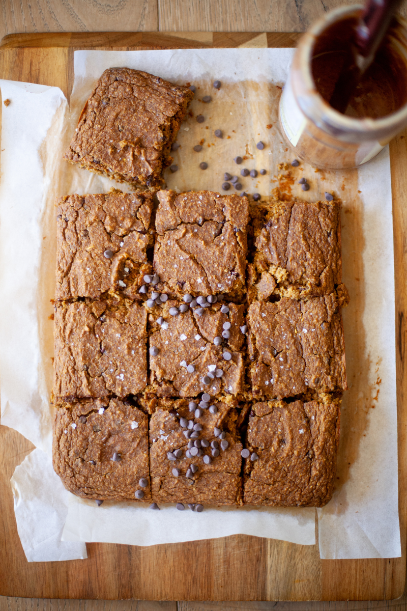 Gluten-free pumpkin bars sliced on a cutting board.
