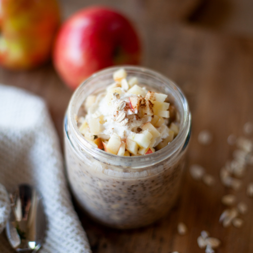 Apple pie overnight protein oats in a jar with toppings.