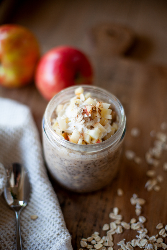 Apple pie overnight protein oats in a jar with toppings.