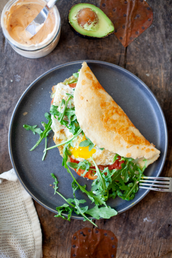 Cheese-fried egg wrap on blue plate.