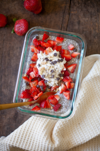 Vanilla chia pudding topped with strawberries and whipped cream.