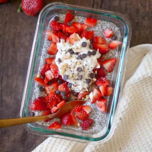 Vanilla chia pudding topped with strawberries and whipped cream.