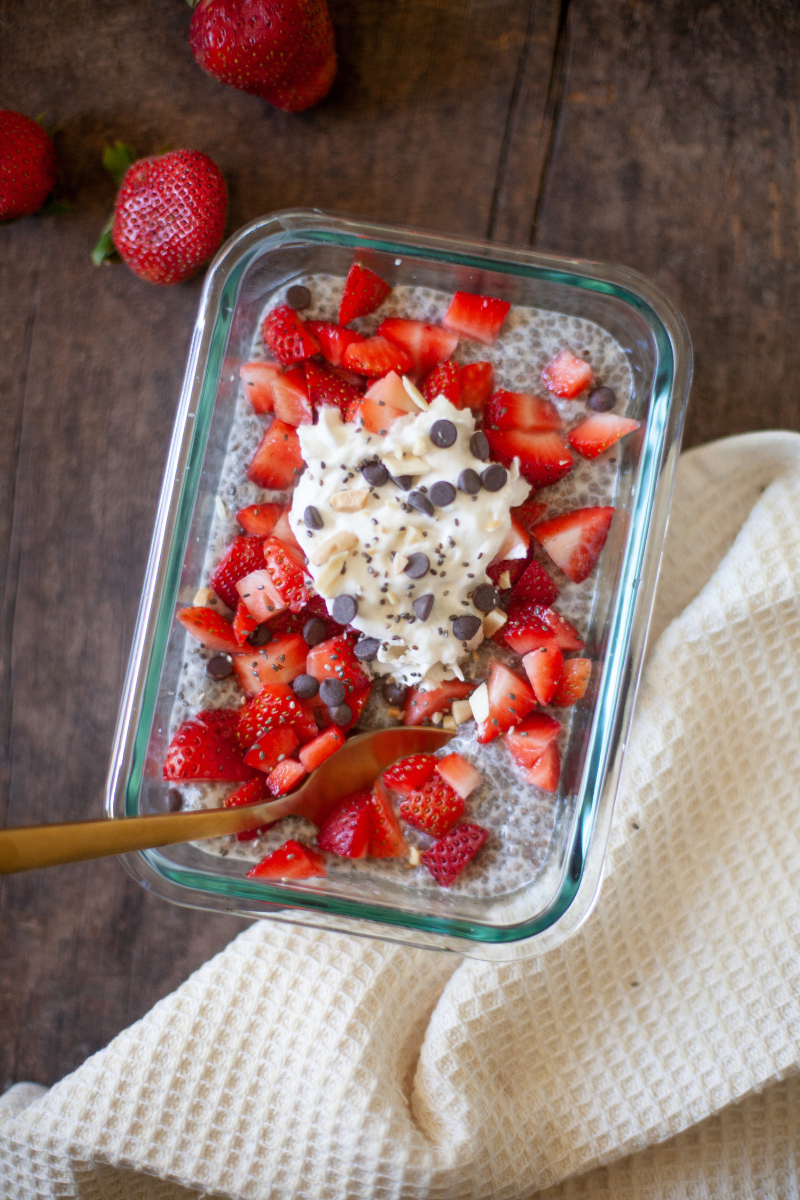 Vanilla chia pudding topped with strawberries and whipped cream.