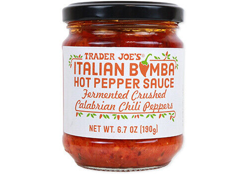 A glass jar of Trader Joe’s Italian Bomba Hot Pepper Sauce—a standout among My Favorite Trader Joe’s Products—features fermented crushed Calabrian chili peppers. The label is white with red and orange text, and the net weight is 6.7 oz (190g).