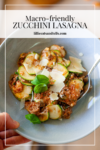 A bowl of Skillet Zucchini Lasagna with ground meat, tomato sauce, melted cheese, basil, and shaved parmesan, held by a hand. Text reads: Macro-friendly Zucchini Lasagna, lillieeatsandtells.com.