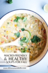 A pot of creamy chicken soup with corn, red peppers, cilantro, and lime, with a wooden spoon resting inside. Text overlay reads 5 Healthy and Macro-friendly Soups for Fall and shows a website link.