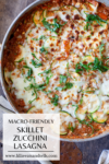 Overhead view of a skillet filled with Skillet Zucchini Lasagna, bubbling with melted cheese and fresh herbs. Text overlay reads: Macro-Friendly Skillet Zucchini Lasagna with a website link at the bottom.