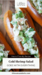 Cold shrimp salad in a toasted brioche bun with text overlay, "Cold Shrimp Salad, Goes with everything."