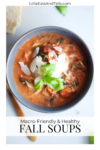 A bowl of tomato-based soup with shredded chicken, spinach, tomato chunks, shaved parmesan, and basil on top. Bread is partially visible beside the bowl. Text reads: 5 Healthy and Macro-friendly Soups for Fall—enjoy this nutritious option as part of your autumn meal rotation!.