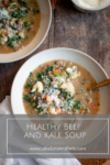 Two bowls of macro-friendly beef and kale soup topped with grated cheese on a wooden table. Text overlay reads: Healthy Macro-Friendly Beef and Kale Soup. www.LillieEatsAndTells.com.