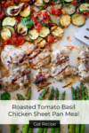 Sheet pan with Roasted Tomato Basil Chicken, asparagus, zucchini, and tomatoes. The food appears golden and garnished with herbs. A metal spatula rests by the vegetables. Text overlay reads Roasted Tomato Basil Chicken Sheet Pan Meal. Get Recipe.