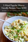 A bowl of chopped salad with a fork, garnished with herbs. Text above reads, 5 Most Popular Macro-friendly Recipes from 2023—discover these delicious options and more at www.lillieeatsandtells.com.