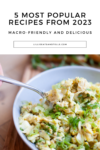 A hand holds a spoon scooping a bowl of chopped salad with chicken, egg, and green onions. Text above reads, 5 Most Popular Macro-friendly Recipes from 2023—delicious dishes that make healthy eating easy.