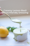 A spoon drizzling creamy green dressing into a small white ramekin, with a lemon and basil leaves in the background. Text reads: Creamy Lemon-Basil Dressing—your new favorite macro-friendly topping.