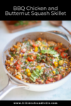 A skillet filled with BBQ chicken, butternut squash, corn, cherry tomatoes, avocado slices, and fresh herbs sits on a light surface. Text above reads BBQ Chicken and Butternut Macro-Friendly Skillet.