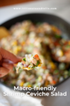 A hand holds a chip topped with vibrant Shrimp Ceviche Salad above a bowl brimming with the colorful salad. Text reads, Macro-friendly Shrimp Ceviche Salad and www.lillieeatsandtells.com.
