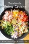 A bowl filled with chopped shrimp, avocado, tomato, red onion, bell peppers, herbs, and a lime half creates a vibrant Shrimp Ceviche Salad. Text reads: Macro-friendly Shrimp Ceviche Salad. www.lillieeatsandtells.com.