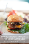 A close-up of a loaded burger with lettuce, tomato, cheese, and a soft bun on a white plate. Text overlay reads: Enjoy Macro-Friendly Favorites for Easter at www.lillieeatsandtells.com.