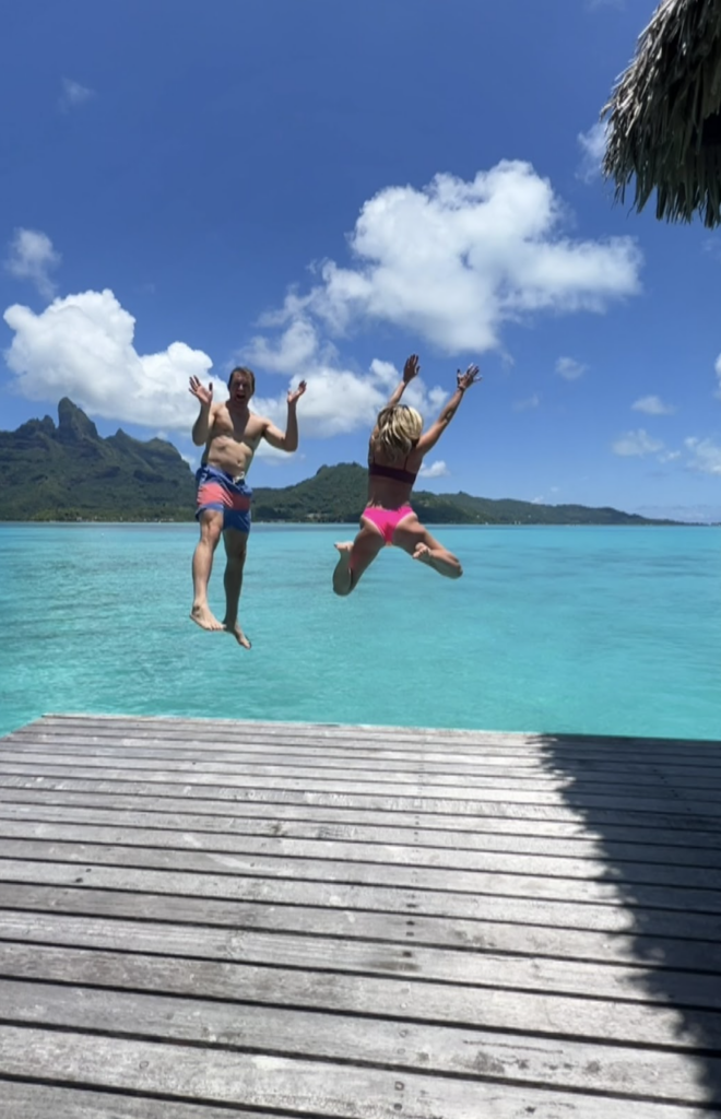 Lillie and Ross jumping off of the deck into the water