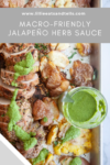 A pan with sliced pork tenderloin, smashed potatoes, and a vibrant Jalapeño Herb Sauce drizzled on top, with extra sauce in a glass jar; text above reads Macro-Friendly Jalapeño Herb Sauce.