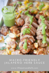 Sliced pork tenderloin with smashed potatoes on a tray, topped with vibrant Jalapeño Herb Sauce. A small jar of the sauce with a spoon is on the side. Text: Macro-Friendly Jalapeño Herb Sauce.